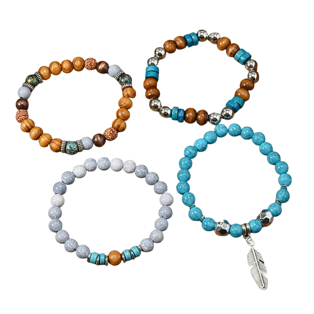 Four beaded stretch bracelets arranged on a white background. One bracelet has orange-brown wooden beads with turquoise and silver accents, one has brown and turquoise beads with silver spacer beads, one has light blue-gray speckled beads with turquoise and brown accents, and one has bright turquoise beads with a silver feather charm.