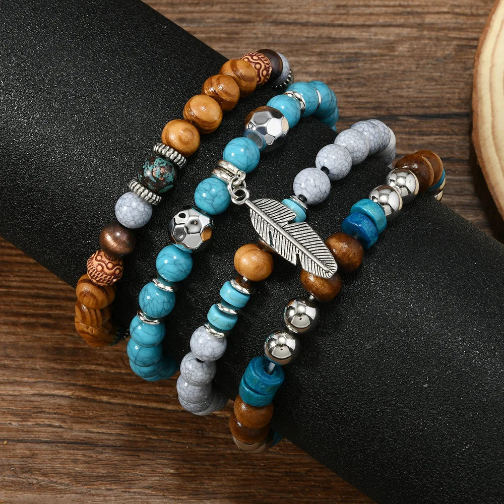 Multiple beaded bracelets with turquoise, brown, and gray beads on a wrist against a wooden background.