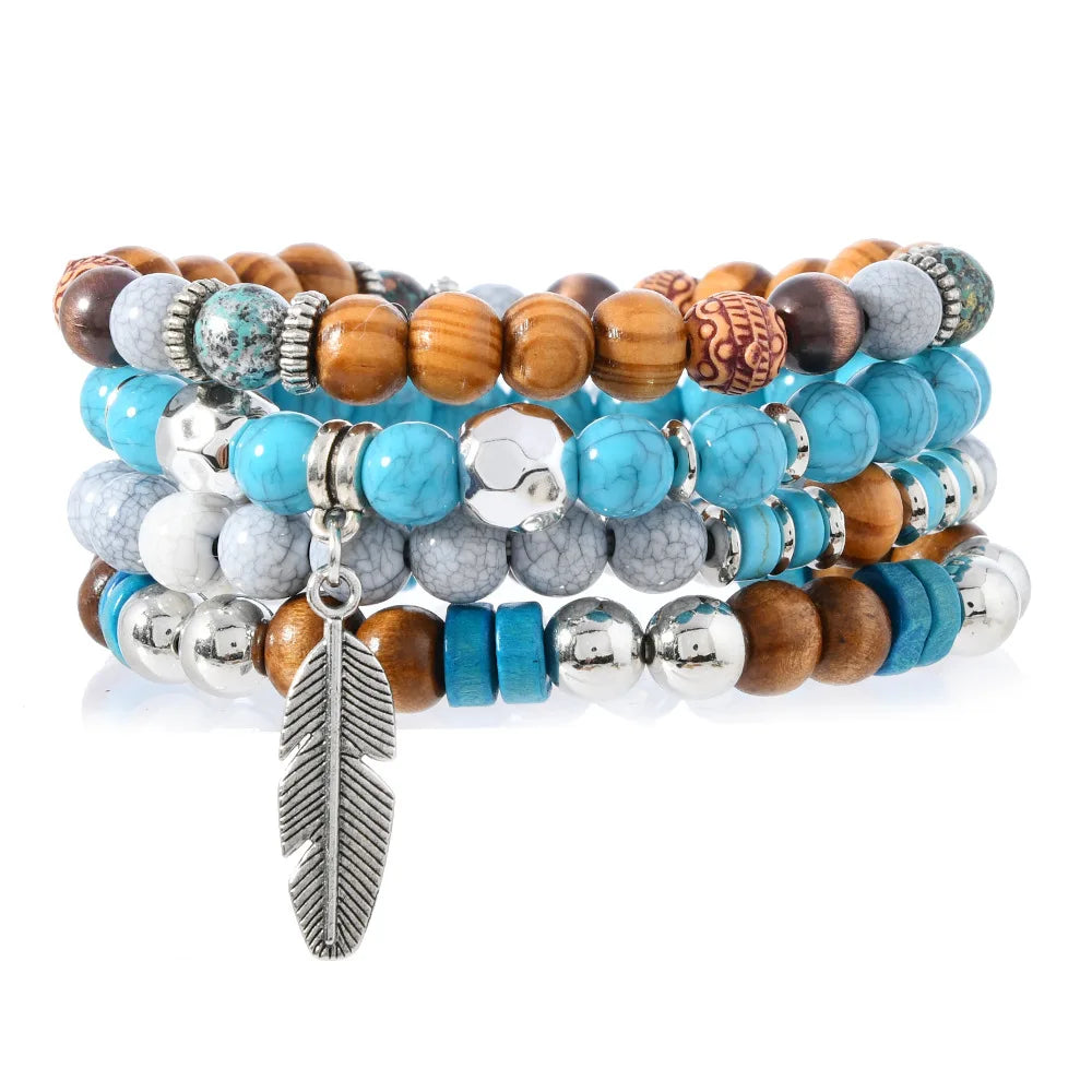 Stack of colorful beaded bracelets with a feather charm on a white background